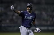 Julio Rodríguez gestures toward the dugout during a baseball game in Oakland, CA